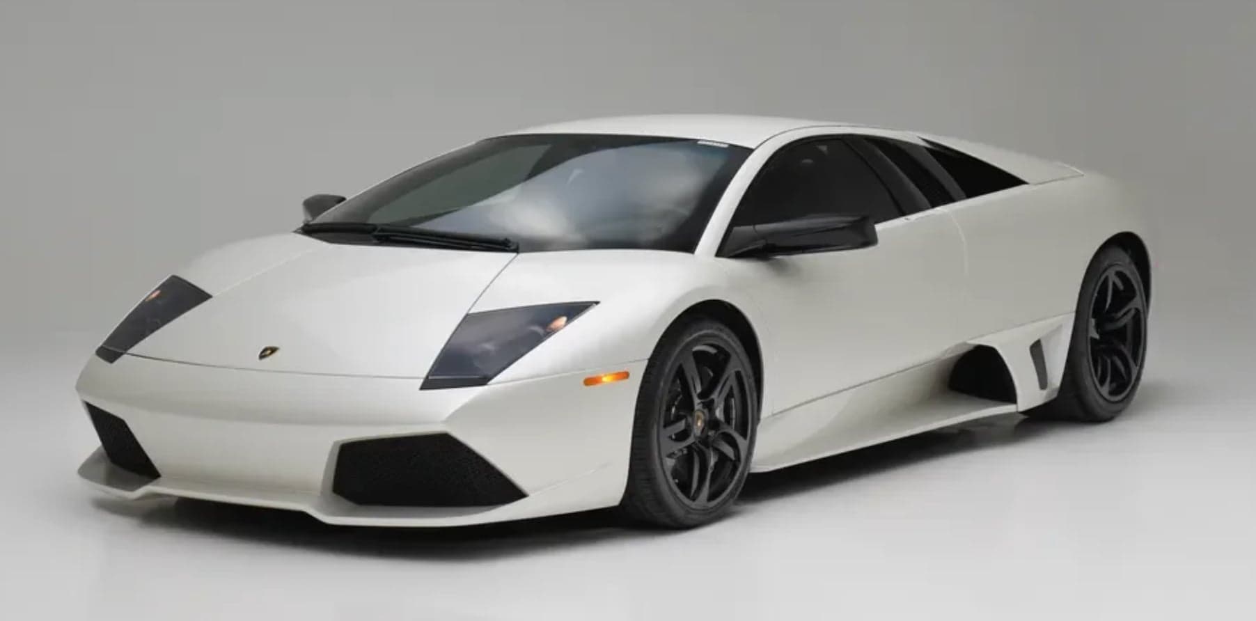 A white Lamborghini Murcielago photographed in a studio