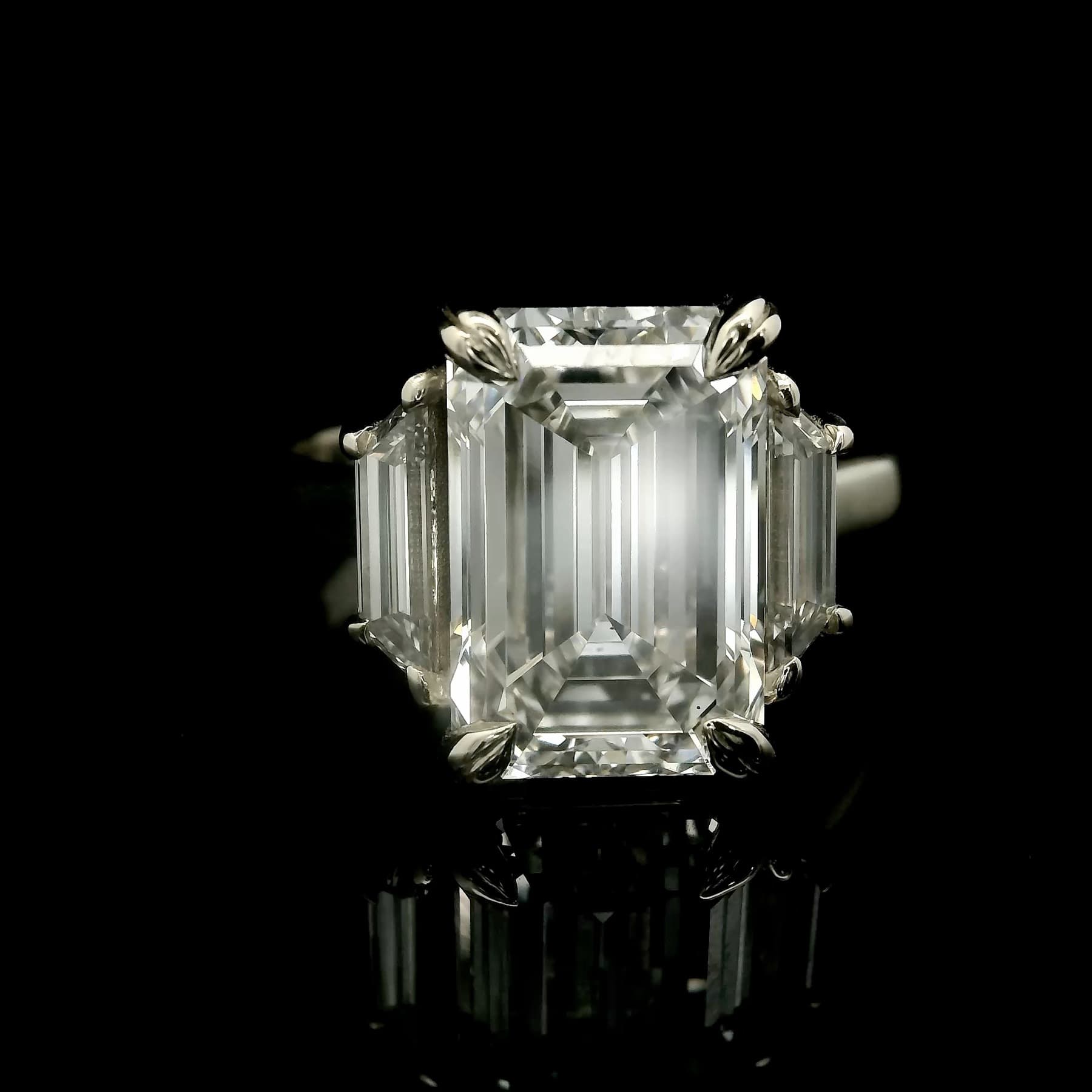 Custom solitaire diamond engagement ring by Eternal Carat, photographed on black