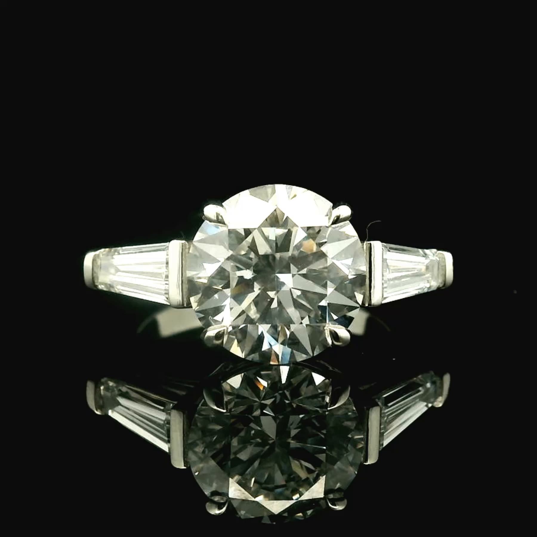 Custom diamond ring with a detailed setting on a dark studio background