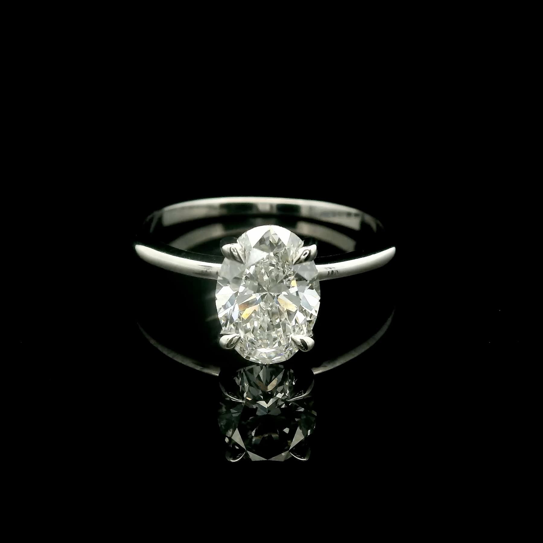 Diamond ring with a raised center stone photographed in studio lighting