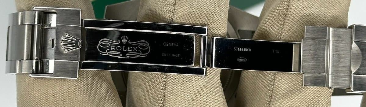 The inside of an open Rolex Oysterlock clasp from a Submariner 116610LV, stamped Rolex, Geneva, Swiss Made, Steelinox and T1U