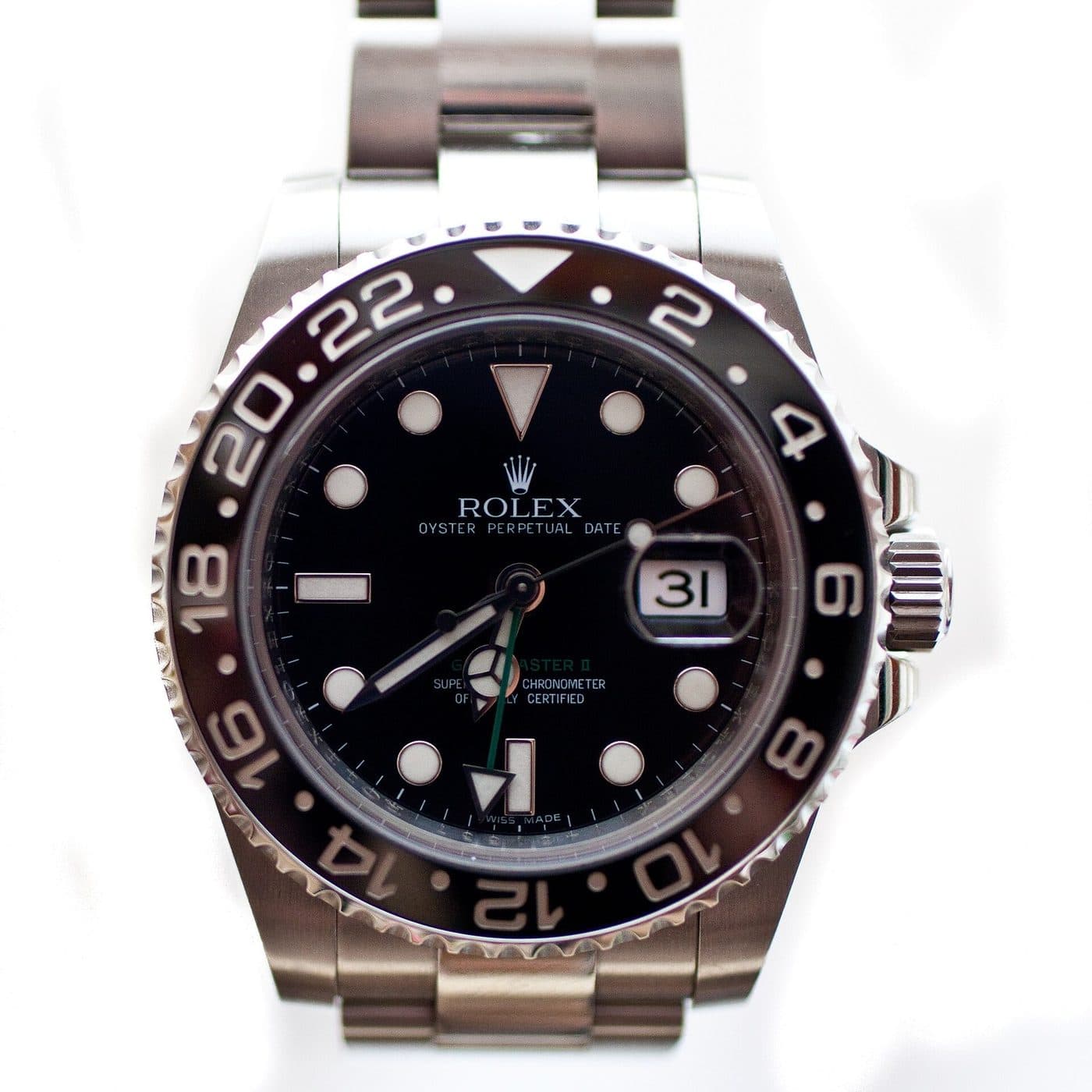 A Rolex GMT-Master II with a black ceramic bezel and green GMT hand on a steel Oyster bracelet, photographed from above