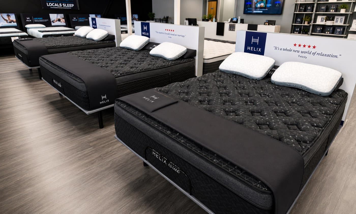 Rows of made-up Helix mattresses in the Jacksonville Bedding showroom
