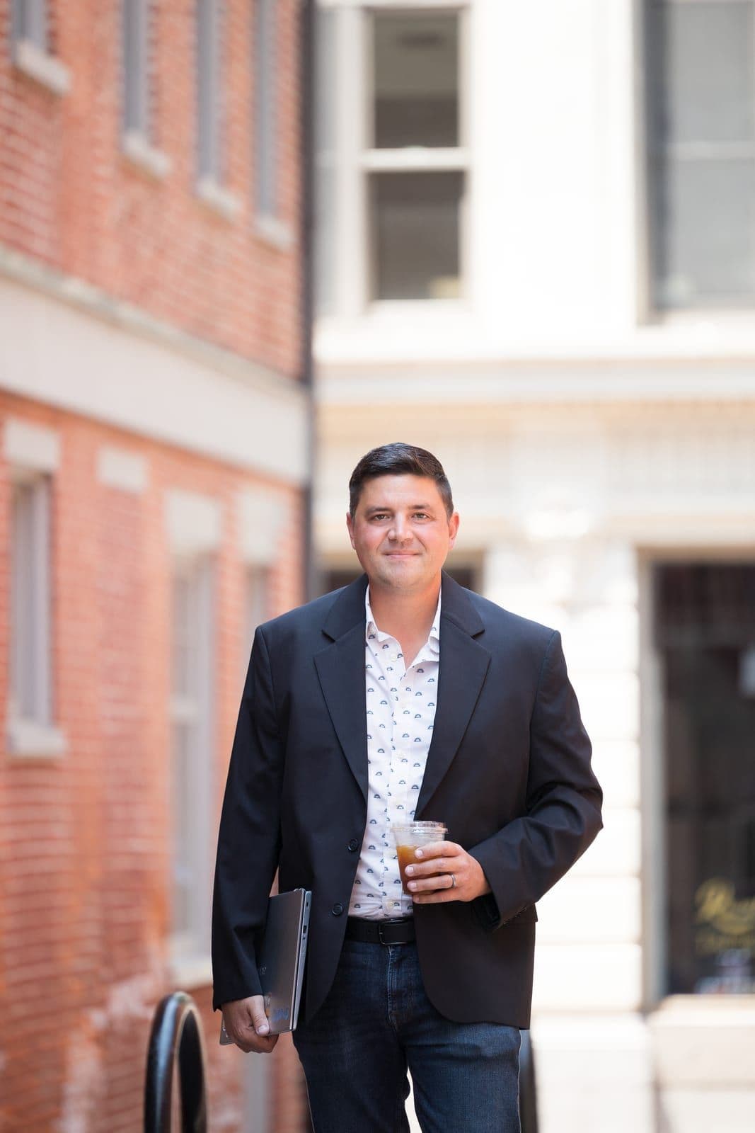 Jeremy Martin, an independent travel advisor, walking with a coffee