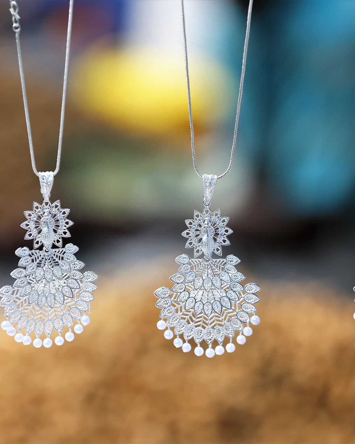 Ornate silver chains and fine jewelry on a dark background