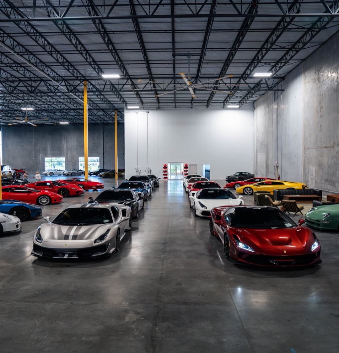 Rows of Ferraris and other exotics lined up inside the warehouse