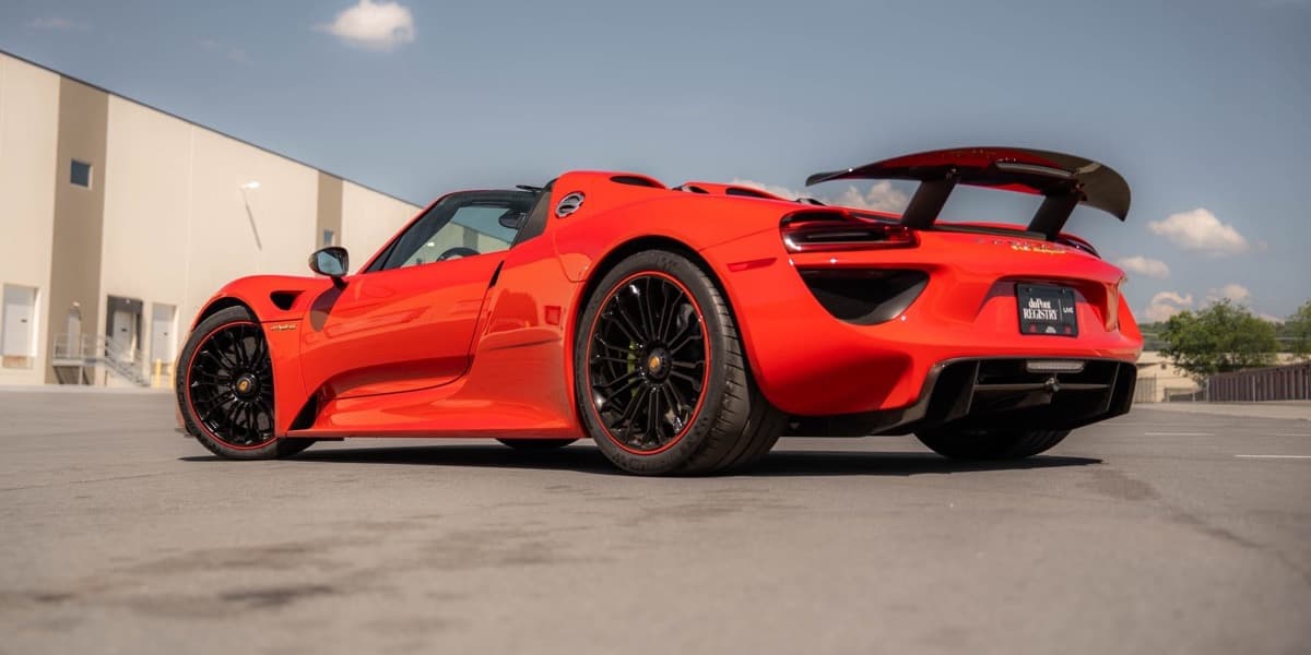A red Porsche 918 Spyder wearing a duPont Registry plate
