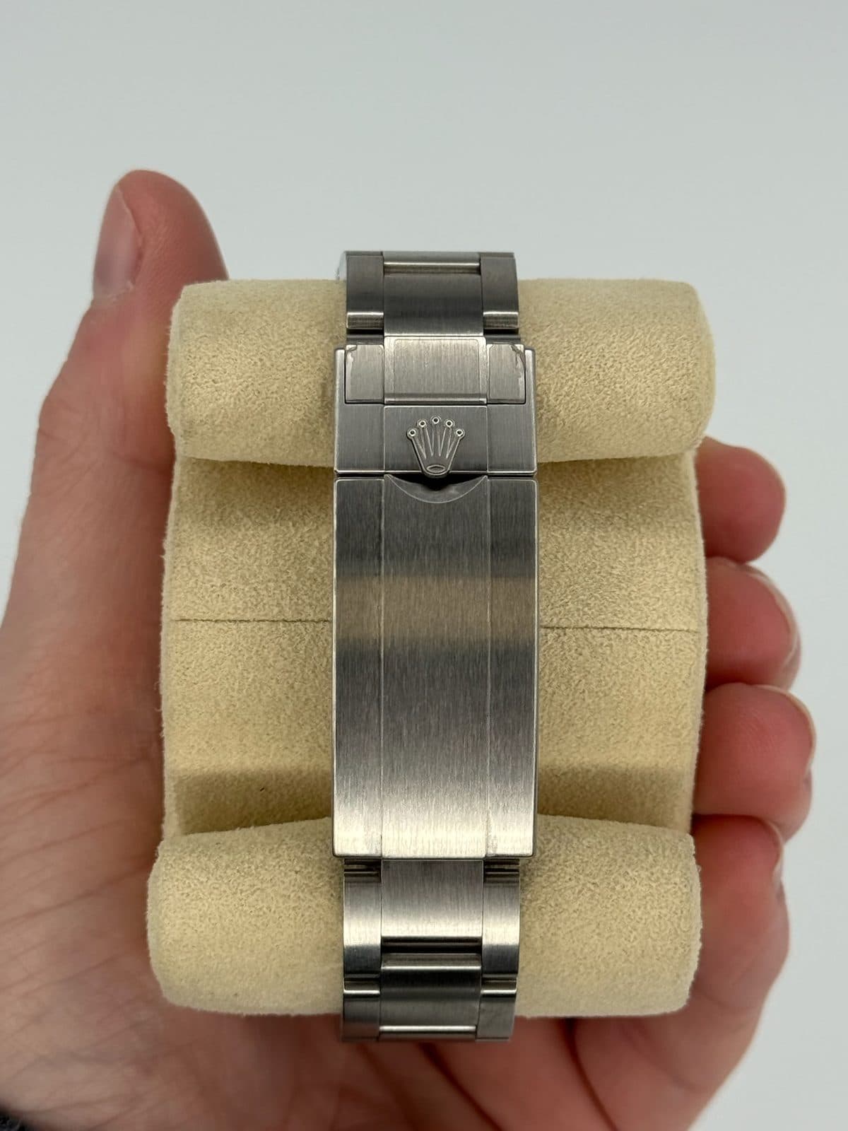 The closed Oysterlock clasp of a Rolex Submariner 116610LN on a watch pillow