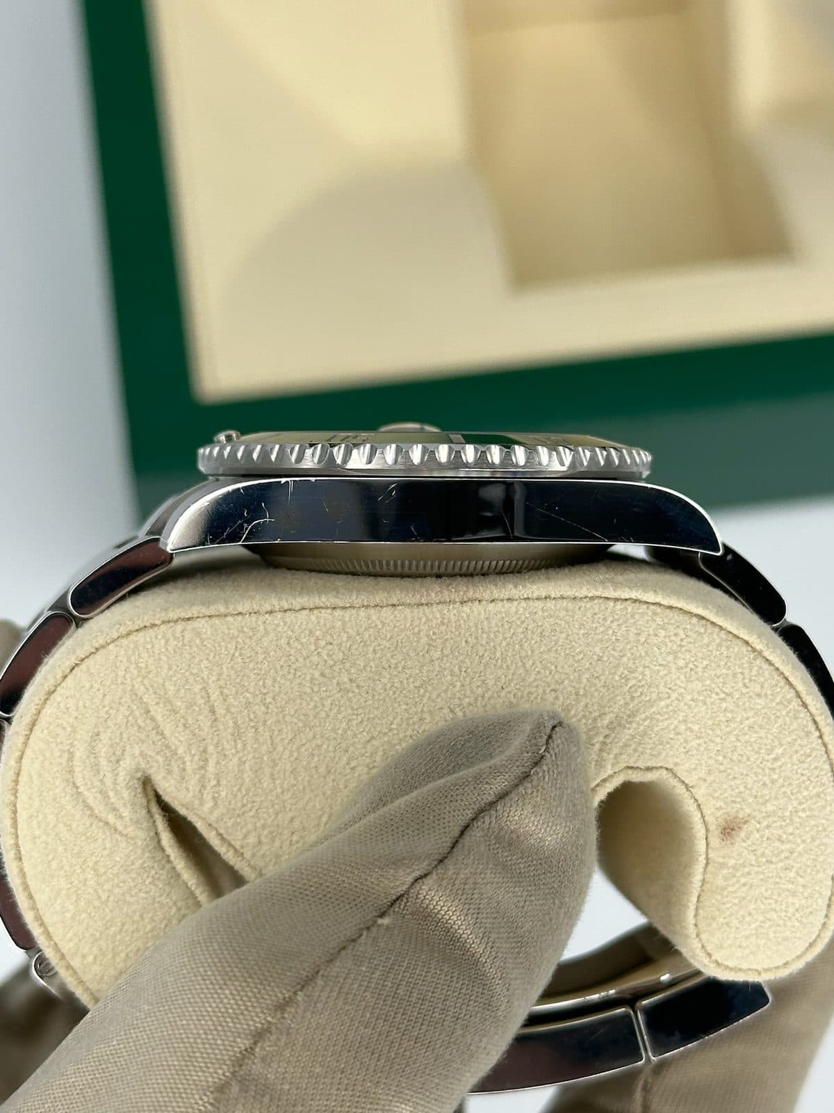 The left side of a Rolex Submariner 116610LV case, showing the bezel edge and lugs