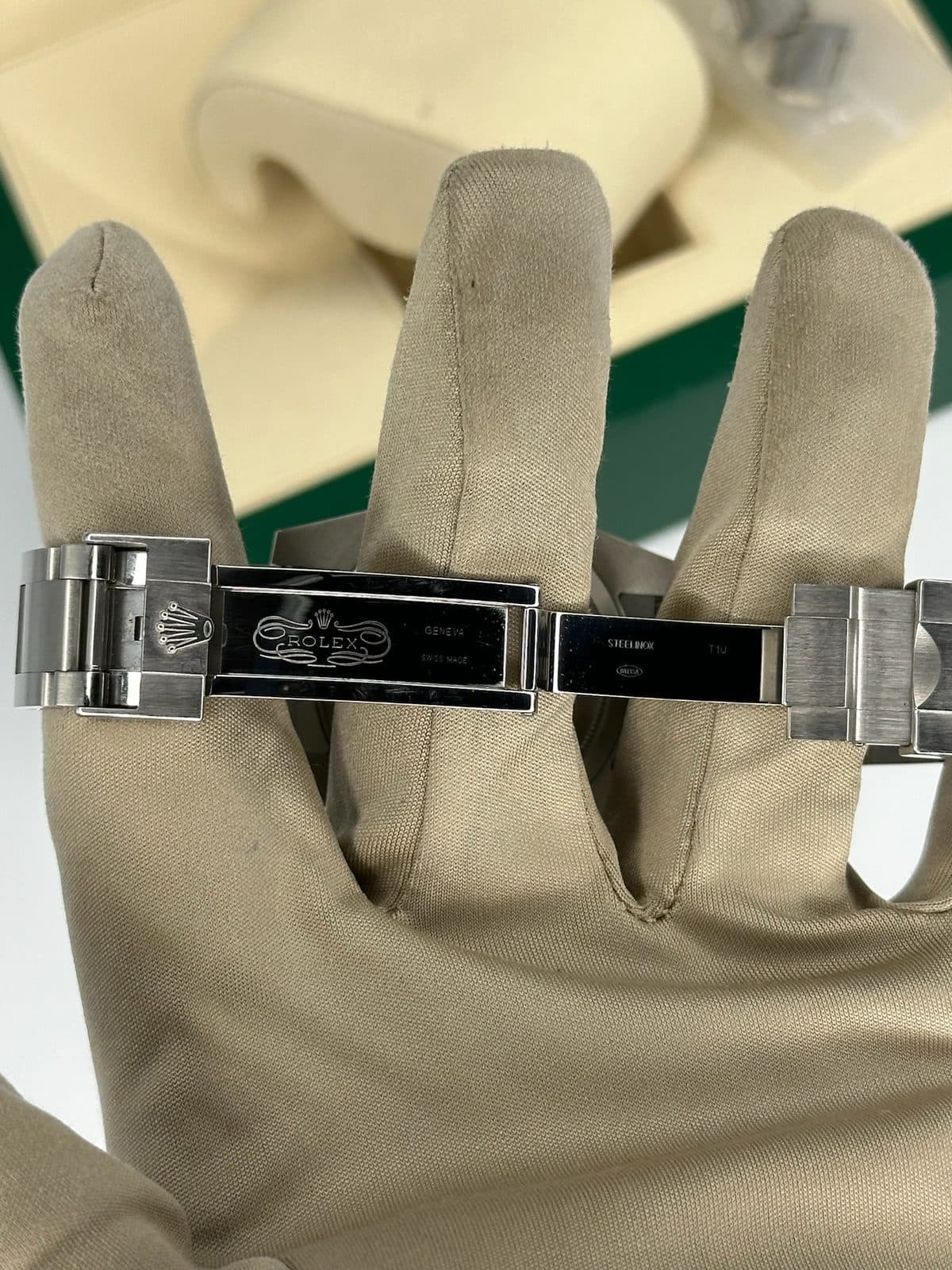 The open clasp of a Rolex Submariner 116610LV, showing the Rolex, Geneva, Swiss Made and Steelinox stamps on the inner blades