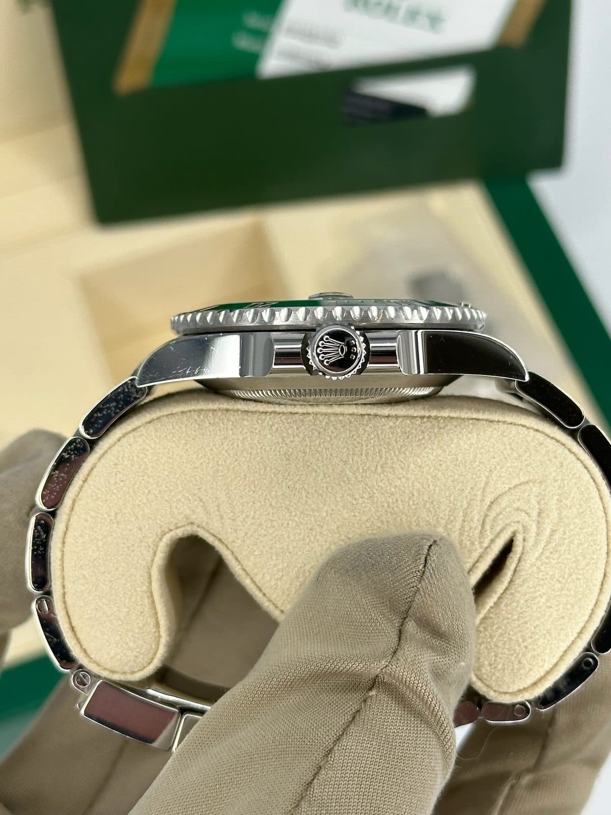 The crown side of a Rolex Submariner 116610LV case, showing the screw-down crown between its crown guards